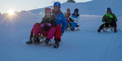 Skiregion - Après Ski im Skigebiet: Schirmbar - Rodeln auf der längsten beleuchteten Rodelbahn der Welt - Wildkogel-Arena Neukirchen & Bramberg